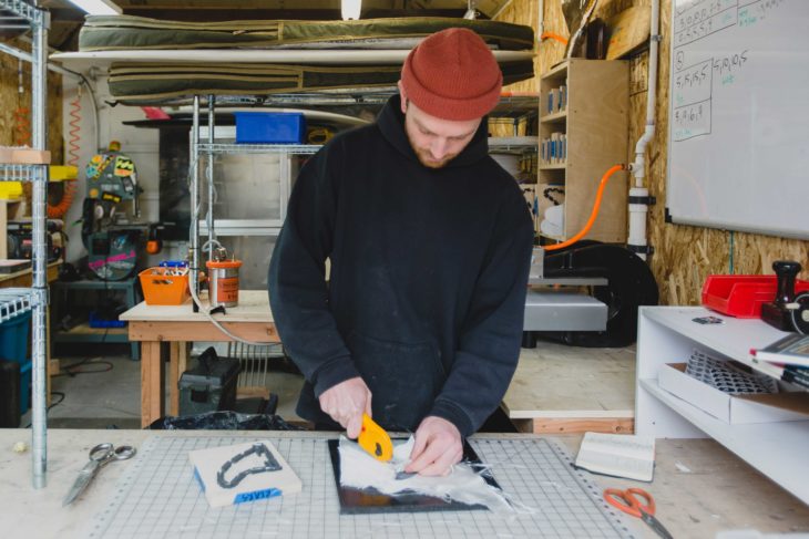 Christian Sellers—creator of Pushfins—working on a new surfboard fin.