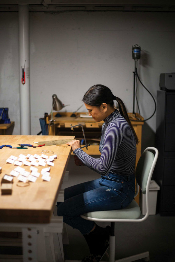 T Ngu shown working on a jewelry piece in her work studio.