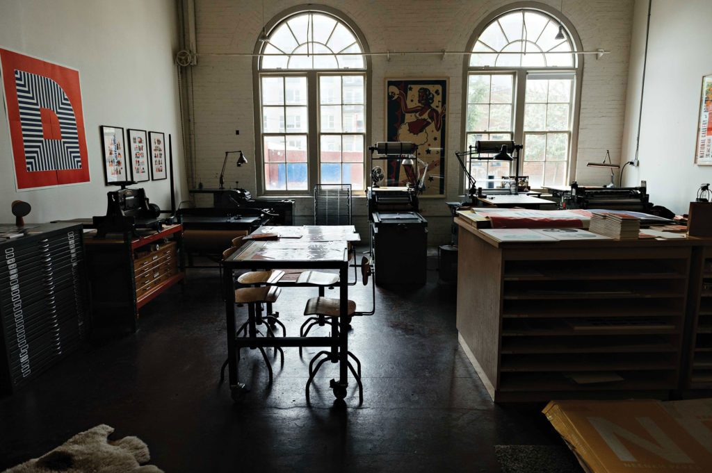 Different print stations are shown throughout the studio.