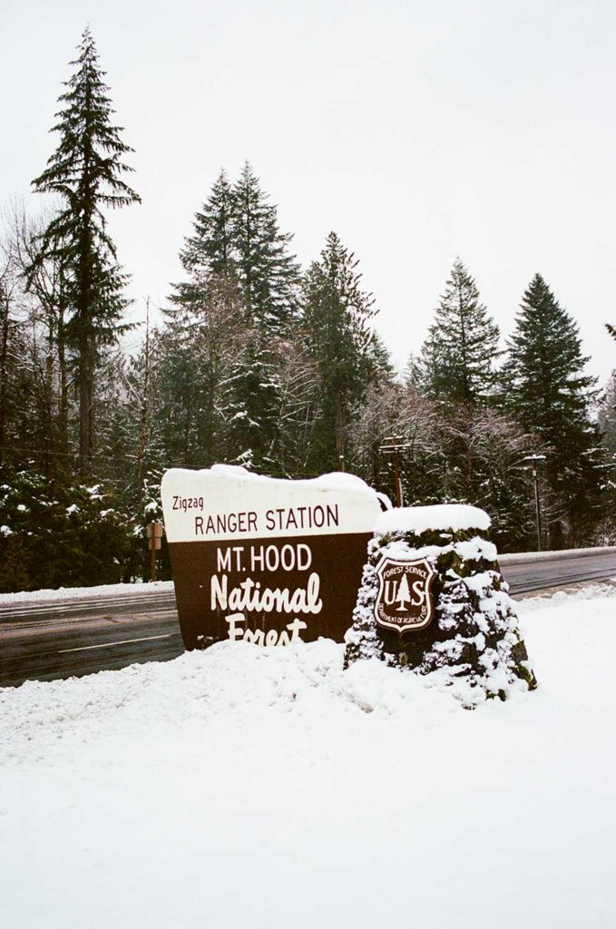 The Mount Hood Ranger Station sign covered by snow