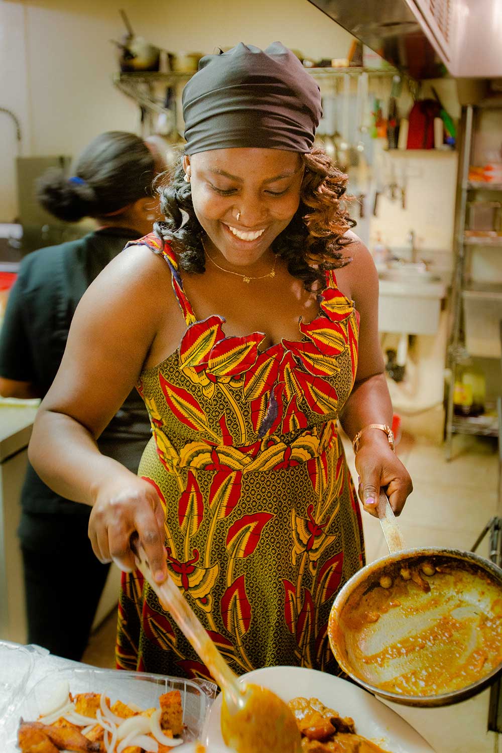 A woman smiling and serving food