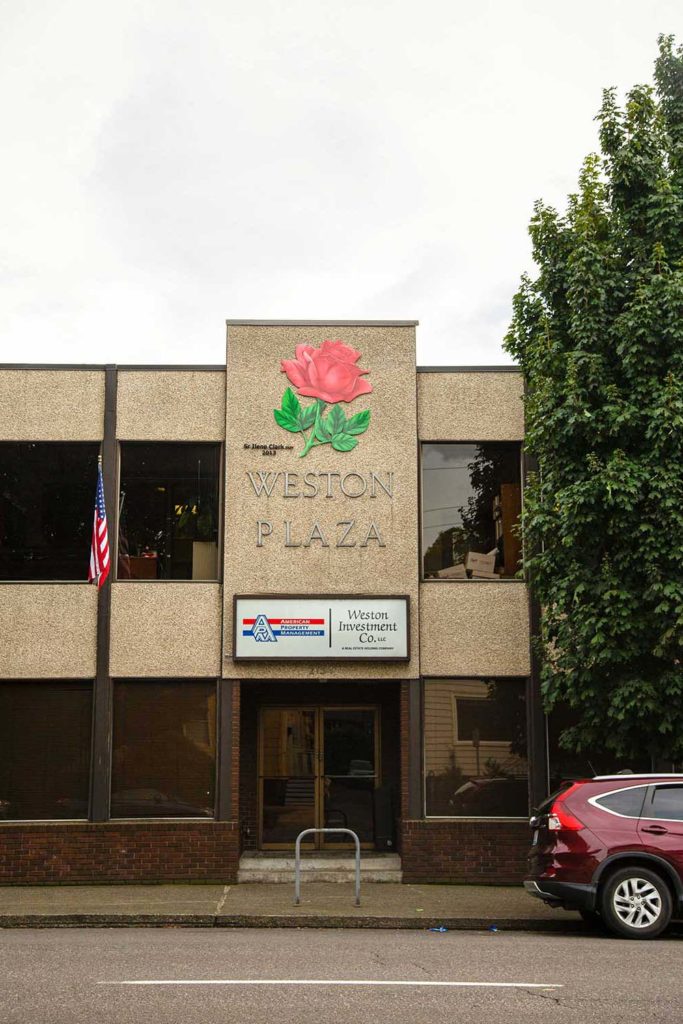 A building with a large rose on its sign